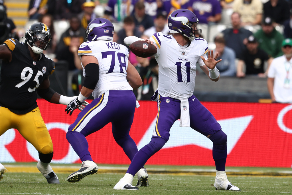 Minnesota Vikings quarterback Carson Wentz (11) attempts to throw during the NFL football game between Minnesota Vikings and Pittsburgh Steelers at Croke Park stadium in Dublin, Sunday, Sept. 28, 2025.(AP Photo/Peter Morrison)