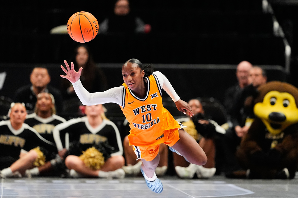 West Virginia's Jordan Harrison chases after the ball after knocking the ball away from Colorado's Jade Masogayo during second half of an NCAA college basketball game in the semifinals of the Big 12 Conference tournament Saturday, March 7, 2026, in Kansas City, Mo. (AP Photo/Charlie Riedel)