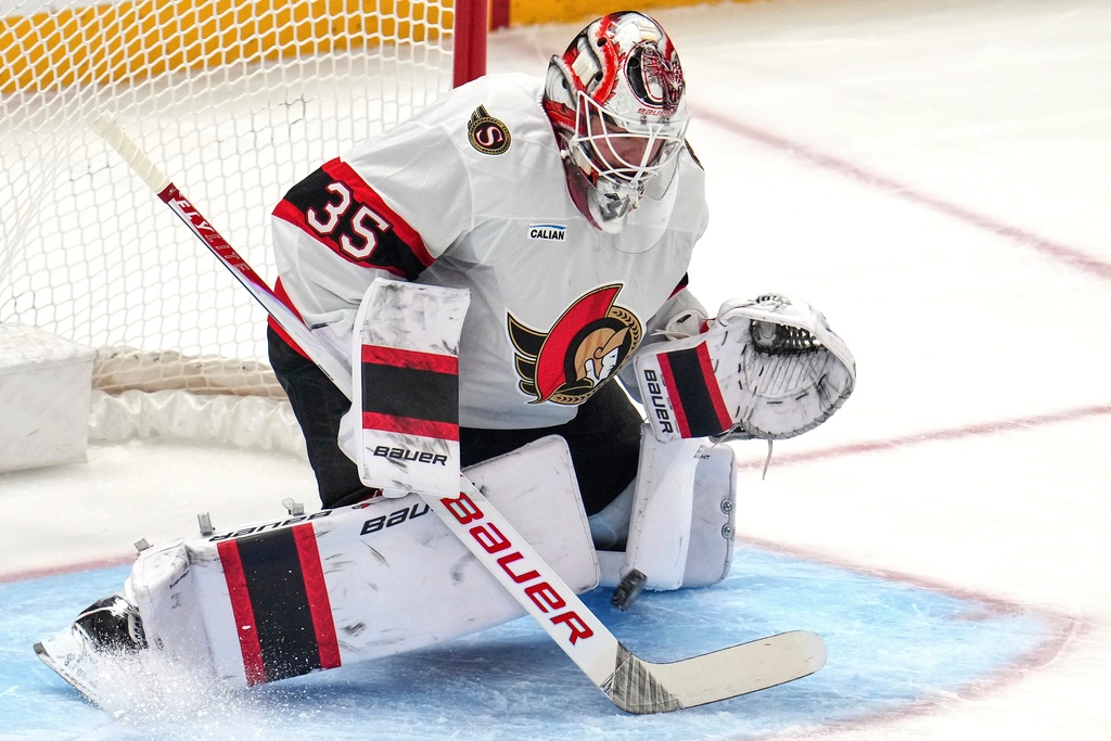 A shot by Pittsburgh Penguins' Egor Chinakhov (not shown) gets between the pads of Ottawa Senators goaltender Linus Ullmark for a goal scoring during the first period of an NHL hockey game in Pittsburgh, Monday, Feb. 2, 2026. (AP Photo/Gene J. Puskar)