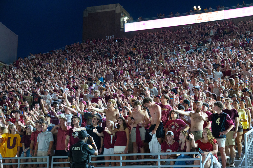 Florida State students perform the tomahawk chop during a stadium-wide power outage before an NCAA college football game against SMU, Monday, Sept. 7, 2026, in Tallahassee, Fla. (AP Photo/Noah Lantor)