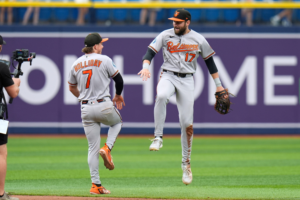 Baltimore Orioles center fielder Colton Cowser (17) and second baseman Jackson Holliday (7) celebrate after the team defeated the Tampa Bay Rays during a baseball game Sunday, Aug. 16, 2026, in St. Petersburg, Fla. (AP Photo/Chris O'Meara)