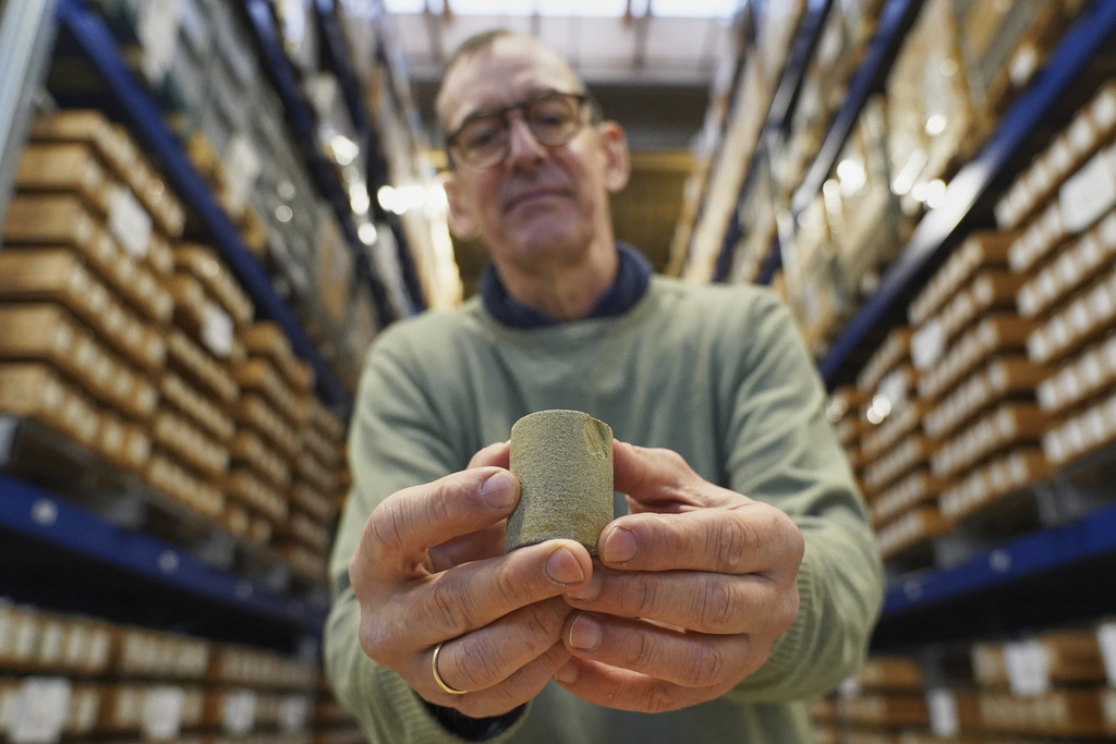 Niels Schovsbo, a senior researcher at the Geological Survey of Denmark and Greenland (GEUS), holds a Greensand reservoir rock core sample at a GEUS facility in Taastrup, Denmark, Monday, Nov. 24, 2025. (AP Photo/James Brooks)