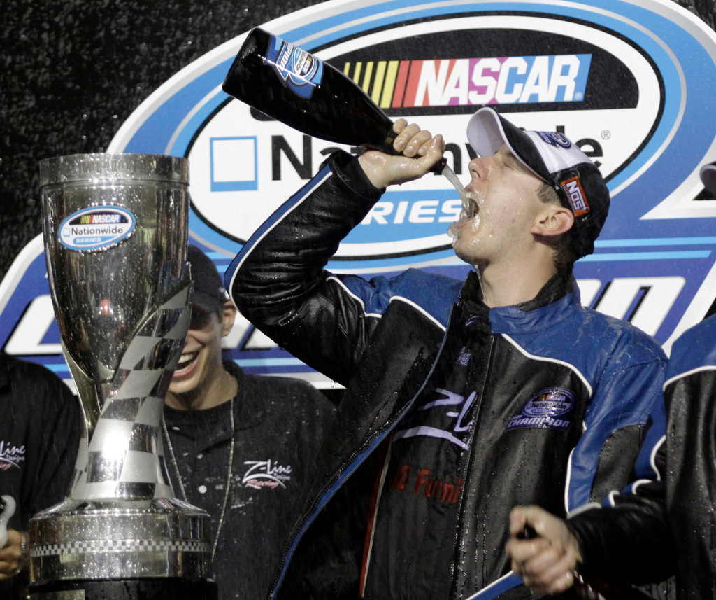 FILE - Kyle Busch drinks champagne after winning the Nationwide series championship and the NASCAR Ford 300 Nationwide series auto race at the Homestead-Miami Speedway in Homestead, Fla., Saturday, Nov. 21, 2009. (AP Photo/Terry Renna, File)