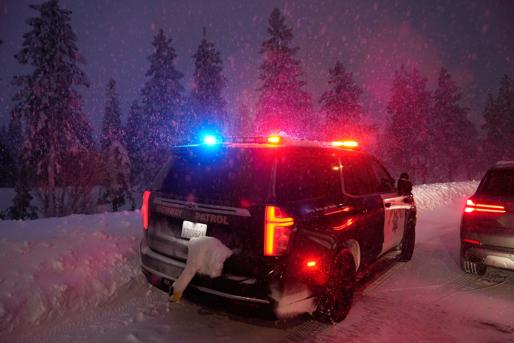 A California Highway Patrol vehicle is parked along a road during a snow storm Wednesday, Feb. 18, 2026, in Placer County, Calif. (AP Photo/Godofredo A. Vásquez)