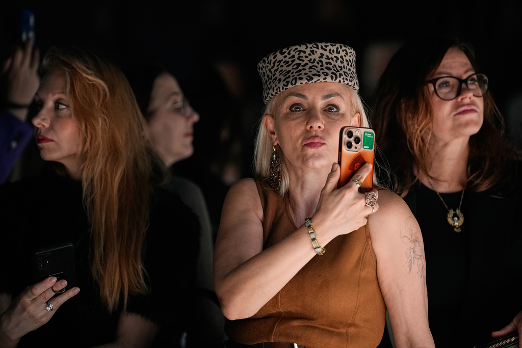 Spectators watch a creation by Turkish designer Emre Erdemoglu, at the Moscow Fashion Week in Moscow, on Tuesday, March 17, 2026. (AP Photo/Alexander Zemlianichenko)