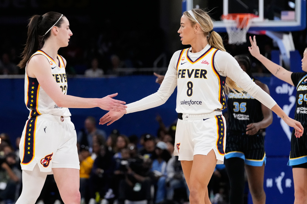 Indiana Fever guard Caitlin Clark, left, gets a high-five from guard Sophie Cunningham during the second half of a WNBA basketball game against the Chicago Sky, Sunday, Aug. 23, 2026, in Chicago. (AP Photo/Nam Y. Huh)