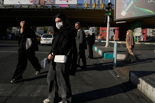 People cross an intersection in northern Tehran, Iran, Sunday, Sept. 28, 2025. (AP Photo/Vahid Salemi) People cross an intersection in northern Tehran, Iran, Sunday, Sept. 28, 2025. (AP Photo/Vahid Salemi)