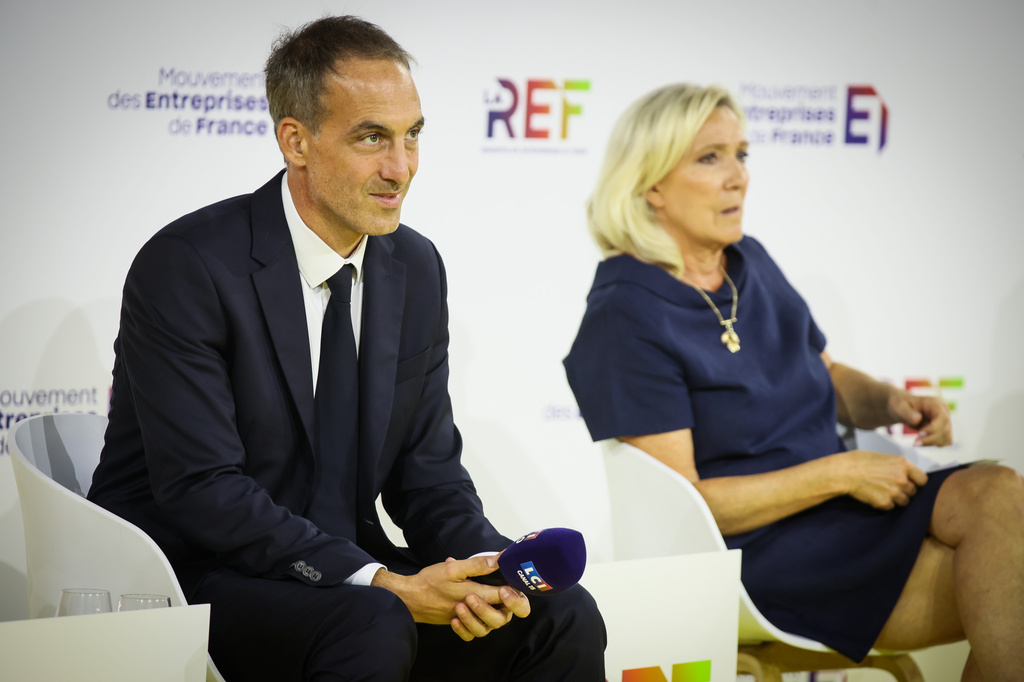 FILE - Co-president of French centre-left party, Place Publique Raphael Glucksmann and Far-right leader Marine Le Pen, candidates at presidential election attend a business meeting organized by the French business organization (MEDEF) in Paris, Thursday, Aug. 27, 2026. (AP Photo/Thomas Padilla, File)