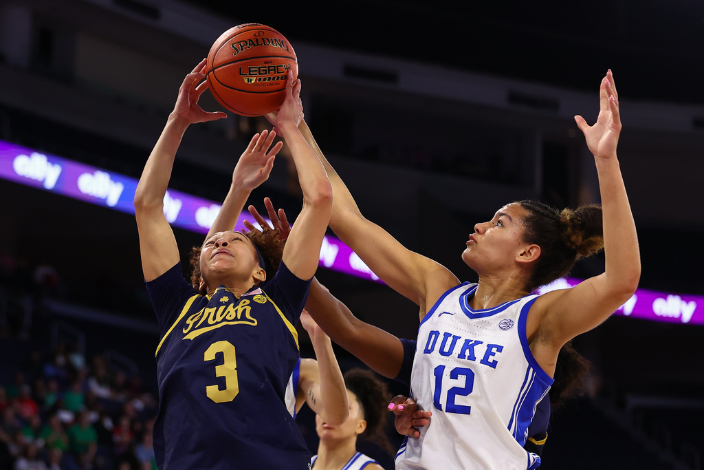 Notre Dame guard Hannah Hidalgo (3) shoots against Duke forward Delaney Thomas (12) during the first half of an NCAA college basketball game in the semifinals of the Atlantic Coast Conference tournament, Saturday, March 7, 2026, in Duluth, Ga. (AP Photo/Colin Hubbard)
