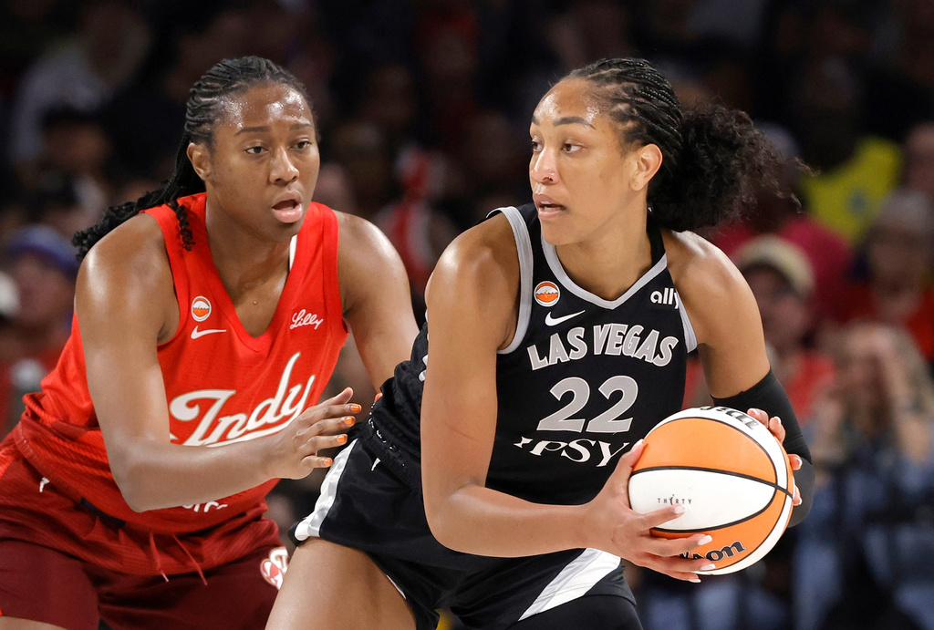 Indiana Fever center-forward Aliyah Boston, left, defends against Las Vegas Aces center A'ja Wilson (22) during the first half of an WNBA basketball game Sunday, July 12, 2026, in Las Vegas. (Steve Marcus/Las Vegas Sun via AP)