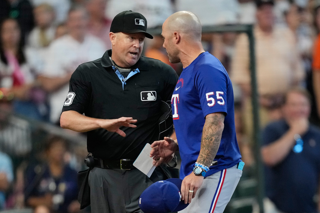 Texas Rangers manager Skip Schumaker (55) argues with home plate umpire Todd Tichenor (13) during the seventh inning of a baseball game Sunday, Aug. 2, 2026, in Houston. (AP Photo/David J. Phillip)
