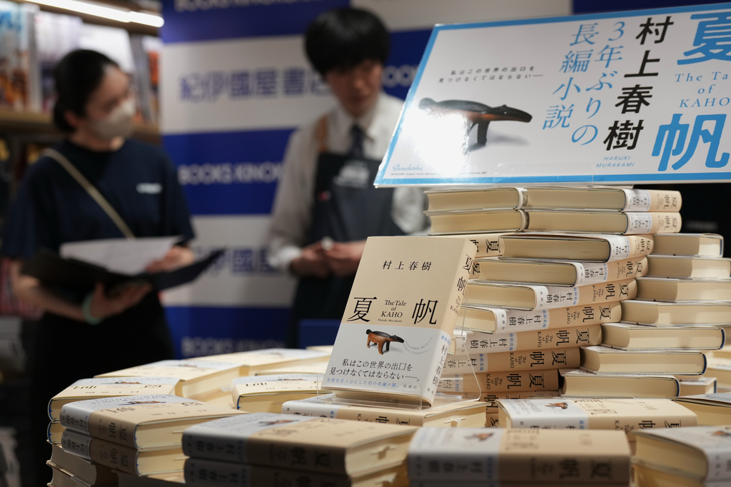 Bookstore staff prepare a countdown event for their customers to receive copies they pre-purchased, of author Haruki Murakami's new book titled "The Tale of Kaho," at the Kinokuniya bookstore in Tokyo, Thursday, July 2, 2026. (AP Photo/Hiro Komae)