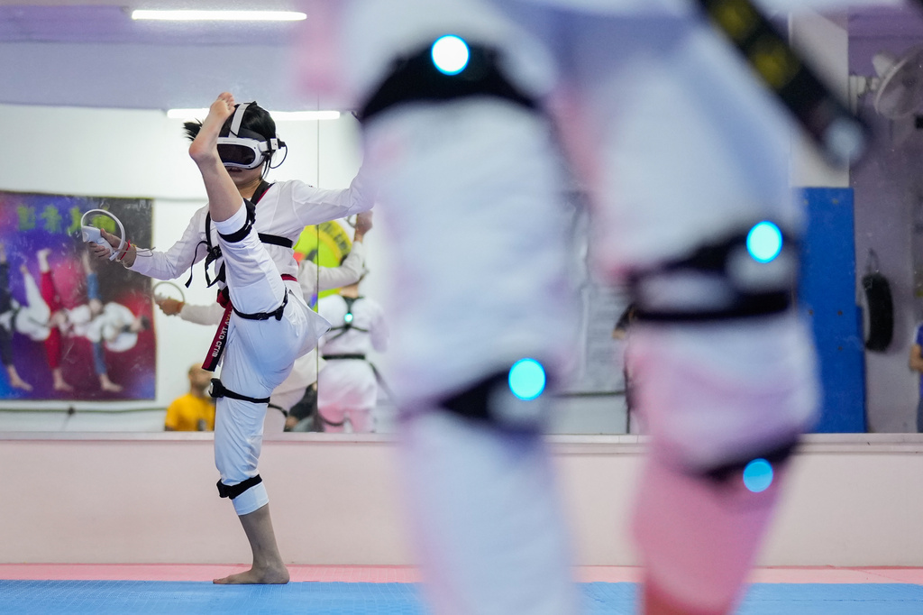 A virtual taekwondo athlete practices at a training center in Puchong, on the outskirts of Kuala Lumpur, Malaysia, Thursday, April 23, 2026. (AP Photo/Vincent Thian)