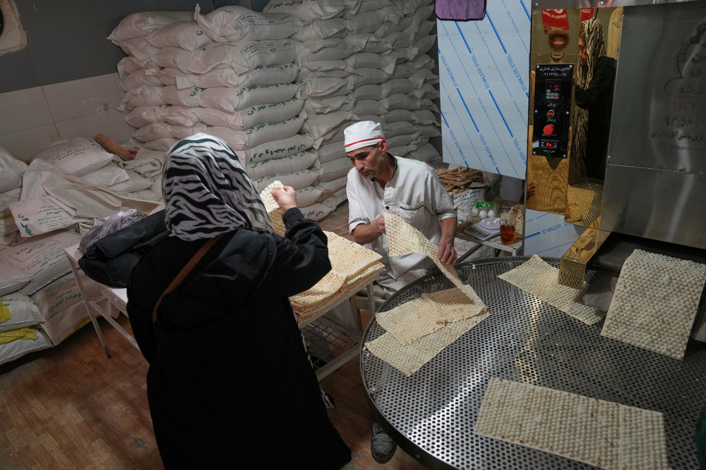 Employees work inside a bakery near Tajrish Bazaar in Tehran, Iran, Tuesday, April 7, 2026. (AP Photo/Francisco Seco)