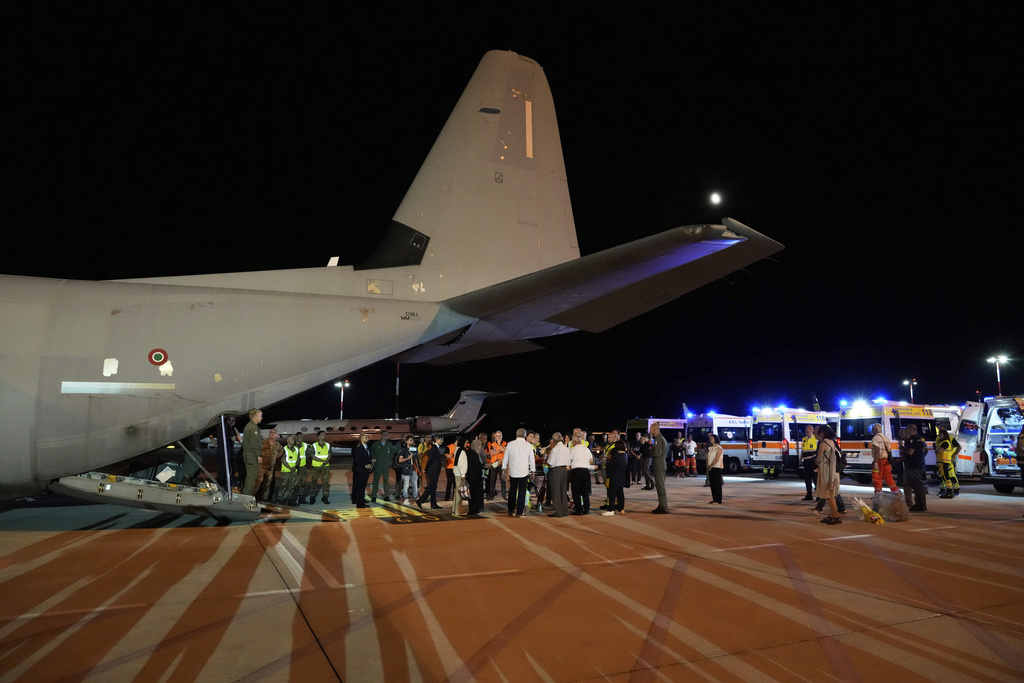 Palestinian children and their families evacuated from Gaza arrive at Rome's Ciampino military airport, Thursday, Aug. 14, 2025. (AP Photo/Gregorio Borgia)