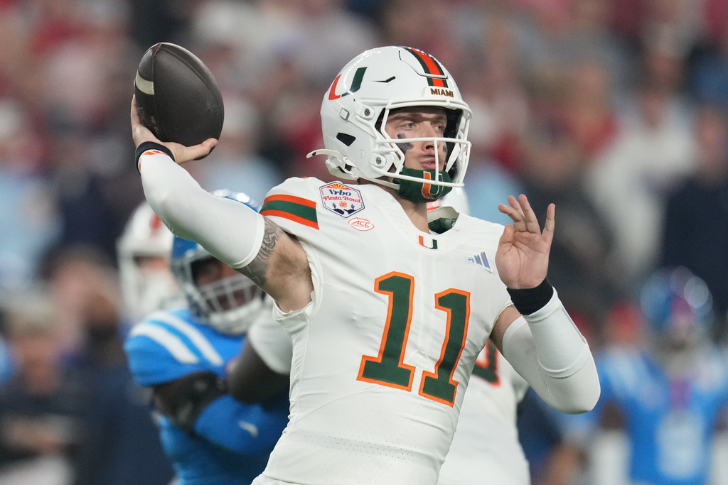 Miami quarterback Carson Beck (11) throws during the first half of the Fiesta Bowl NCAA college football playoff semifinal game against Mississippi, Thursday, Jan. 8, 2026, in Glendale, Ariz. (AP Photo/Rick Scuteri)