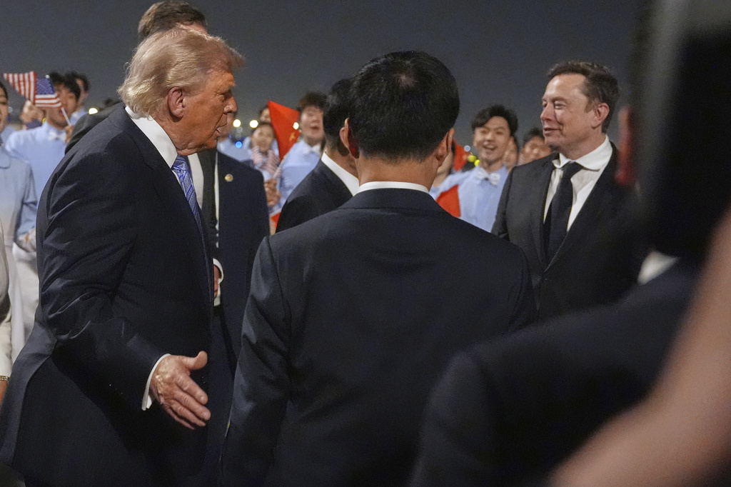 President Donald Trump talks with Elon Musk, right, during and arrival ceremony Wednesday, May 13, 2026, at Beijing Capital International Airport in Beijing. (AP Photo/Mark Schiefelbein)