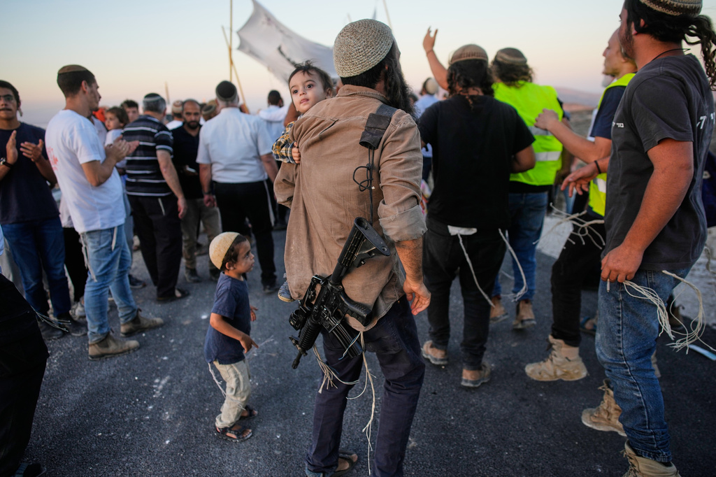 Israeli settlers celebrate the inauguration of a newly built synagogue at the occupied West Bank ilegal outpost of Homesh, Wednesday, Sept. 16, 2026. (AP Photo/Ohad Zwigenberg)