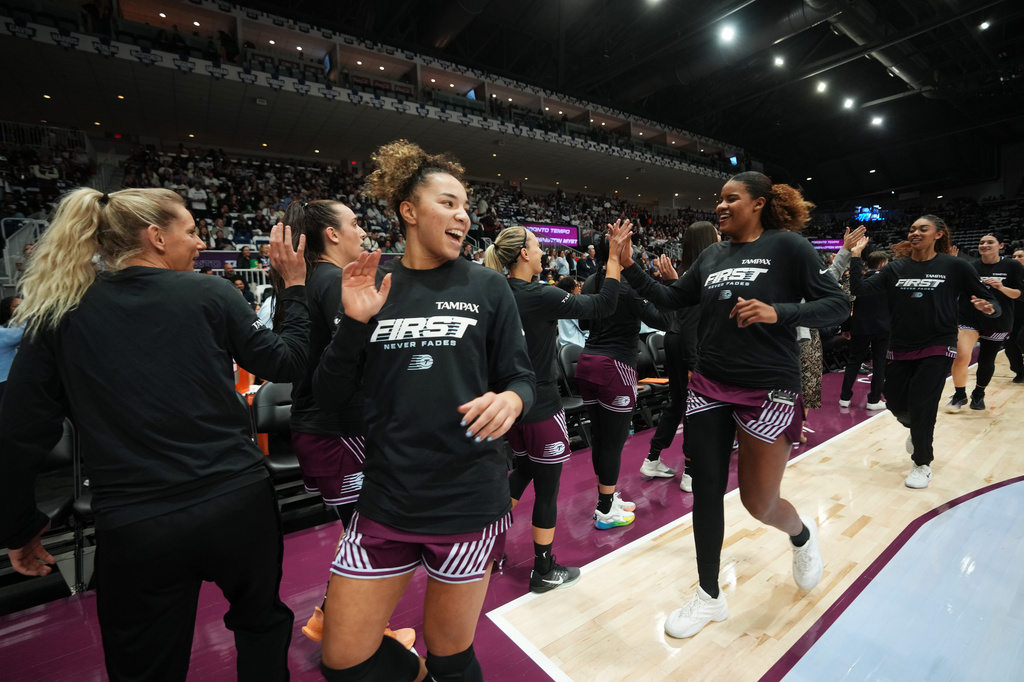 Toronto Tempo's Kiki Rice, front right, high-fives teammates prior to a WNBA basketball game against the Washington Mystics in Toronto, Friday, May 8, 2026. (Nathan Denette/The Canadian Press via AP)