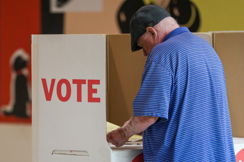 A voter looks over a ballot at a polling location inside the Shoppes at Northpark mall, Tuesday, June 16, 2026, in Oklahoma City. (AP Photo/Nate Billings)