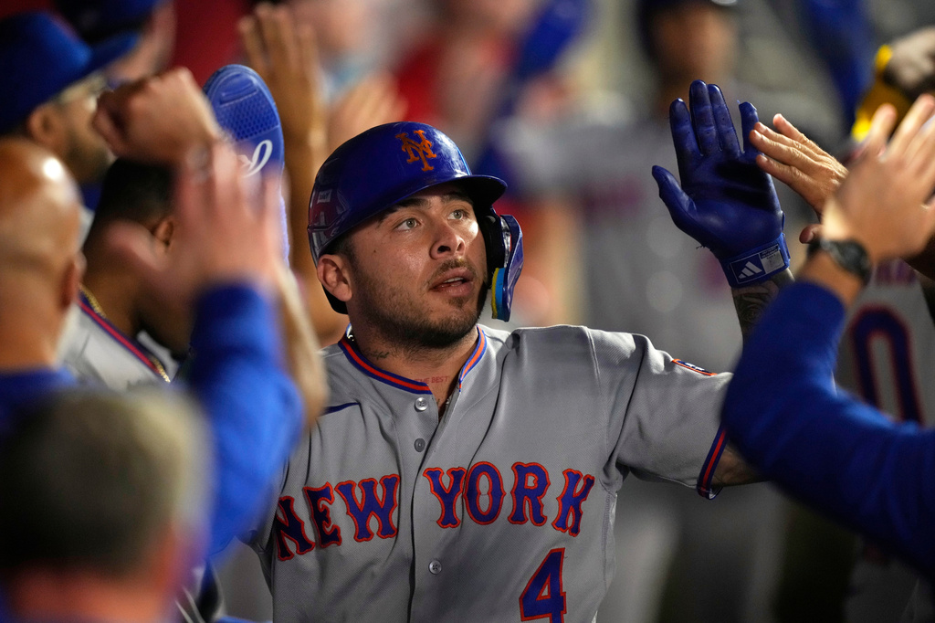 New York Mets catcher Francisco Alvarez is congratulated by teammates in the dugout after Marcus Semien hit a two RBI single during the sixth inning of a baseball game Friday, May 1, 2026, in Anaheim, Calif. (AP Photo/Mark J. Terrill)