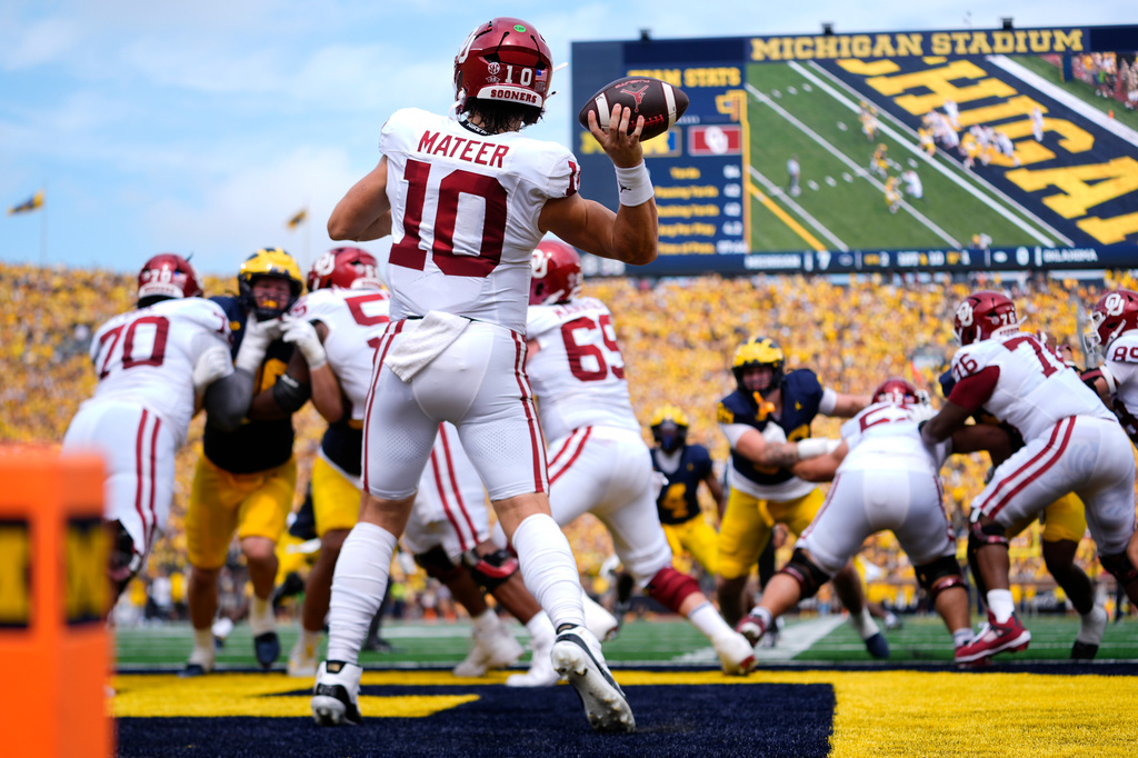 Oklahoma quarterback John Mateer (10) throws from the end zone against Michigan in the first half of an NCAA college football game Saturday, Sept. 12, 2026, in Ann Arbor, Mich. (AP Photo/Paul Sancya)