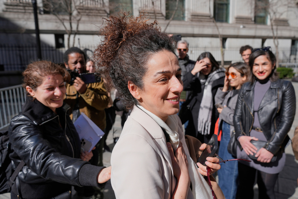 FILE - Masih Alinejad greets friends and supporters outside the federal courthouse after testifying at the trial of two men accused of allegedly plotting to kill her in New York, March 18, 2025. (AP Photo/Seth Wenig, File)