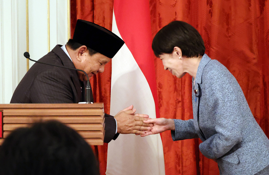 Indonesian President Prabowo Subianto, left, shakes hands with Japanese Prime Minister Sanae Takaichi after they announced their statements at the Akasaka guesthouse in Tokyo Tuesday, March 31, 2026. (Yoshikazu Tsuno/Pool Photo via AP)