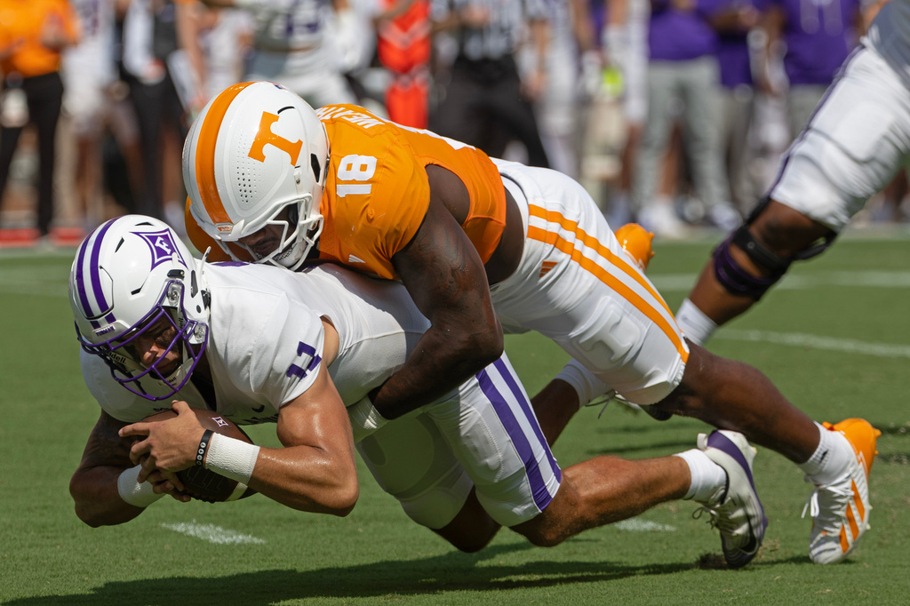 Furman quarterback Jake Garcia (11) is sacked by Tennessee defensive lineman Tyree Weathersby (18) during the first half of an NCAA college football game Saturday, Sept. 5, 2026, in Knoxville, Tenn. (AP Photo/Wade Payne)