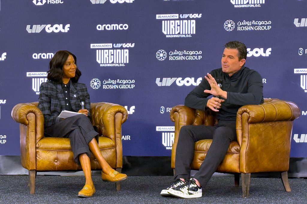 LIV Golf CEO Scott O'Neil, right, answers questions from LIV media official Ilana Finley at Trump National Golf Club in Sterling, Va., Tuesday, May 5, 2026. (AP Photo/Ben Nuckols)