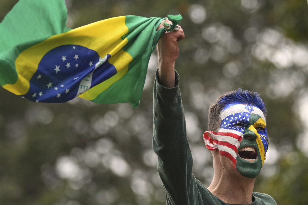 A supporter of former President Jair Bolsonaro protests his Supreme Court trial for allegedly leading a coup plot to keep him in office after his 2022 election defeat, in Sao Paulo, Sunday, Sept. 7, 2025. (AP Photo/Andre Penner)