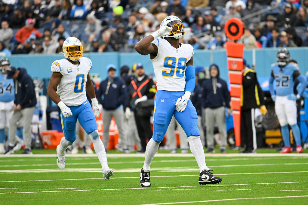 Los Angeles Chargers linebacker Odafe Oweh (98) celebrate after sacking Tennessee Titans quarterback Cam Ward during the second half of an NFL football game Sunday, Nov. 2, 2025, in Nashville, Tenn. (AP Photo/John Amis)