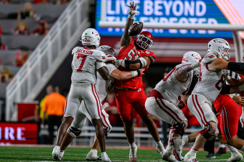 Utah defensive tackle Karson Kaufusi (51) bats down the pass of Arkansas quarterback KJ Jackson (7) during the second half of an NCAA college football game Saturday, Sept. 12, 2026, in Salt Lake City. (AP Photo/Tyler Tate)