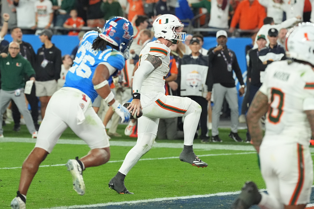 Miami quarterback Carson Beck (11) runs to the end zone for a touchdown during the second half of the Fiesta Bowl NCAA college football playoff semifinal game against Mississippi, Thursday, Jan. 8, 2026, in Glendale, Ariz. (AP Photo/Ross D. Franklin)