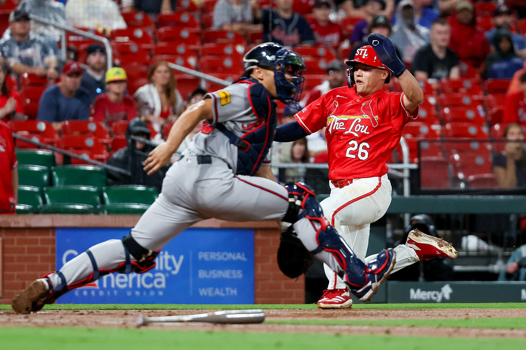 St. Louis Cardinals' JJ Wetherholt (26) scores a run ahead of the throw to Atlanta Braves' Drake Baldwin during the sixth inning of a baseball game Friday, July 10, 2026, in St. Louis. (AP Photo/Scott Kane)