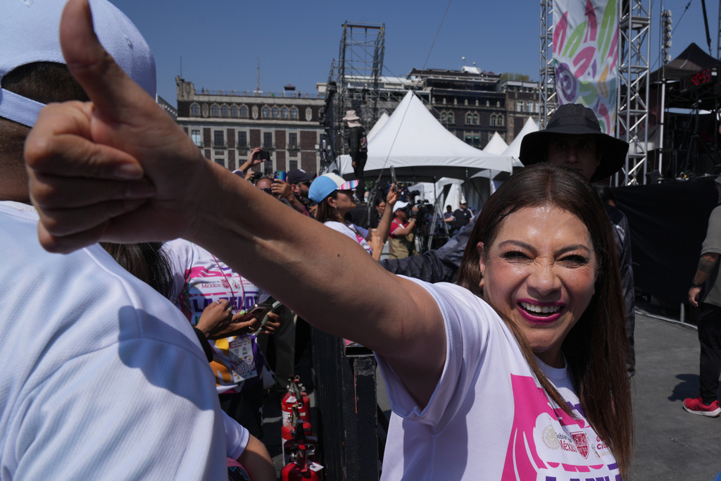 Mexico City Mayor Clara Brugada gestures during an attempt to set the Guinness World Record for the "largest soccer class" at the Zocalo in Mexico City, Sunday, March 15, 2026. (AP Photo/Marco Ugarte)