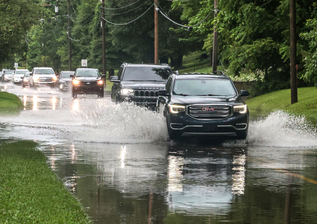 Drivers maneuver their vehicles through high water flooding West Parrish Avenue after a heavy rainfall, Saturday, June 27, 2026, in Owensboro, Ky. (Greg Eans/The Messenger-Inquirer via AP)