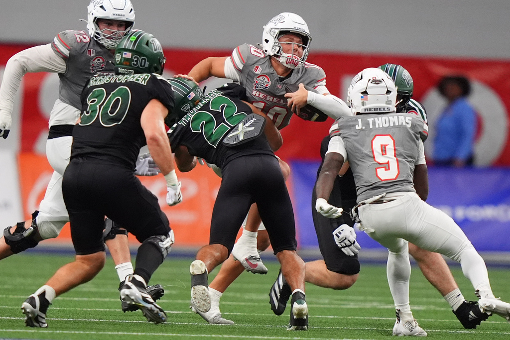 UNLV quarterback Anthony Colandrea (10) is stopped by Ohio safety Jalen Thomeson (22) while running during the first half of the Frisco Bowl NCAA college football game Tuesday, Dec. 23, 2025, in Frisco, Texas. (AP Photo/LM Otero)