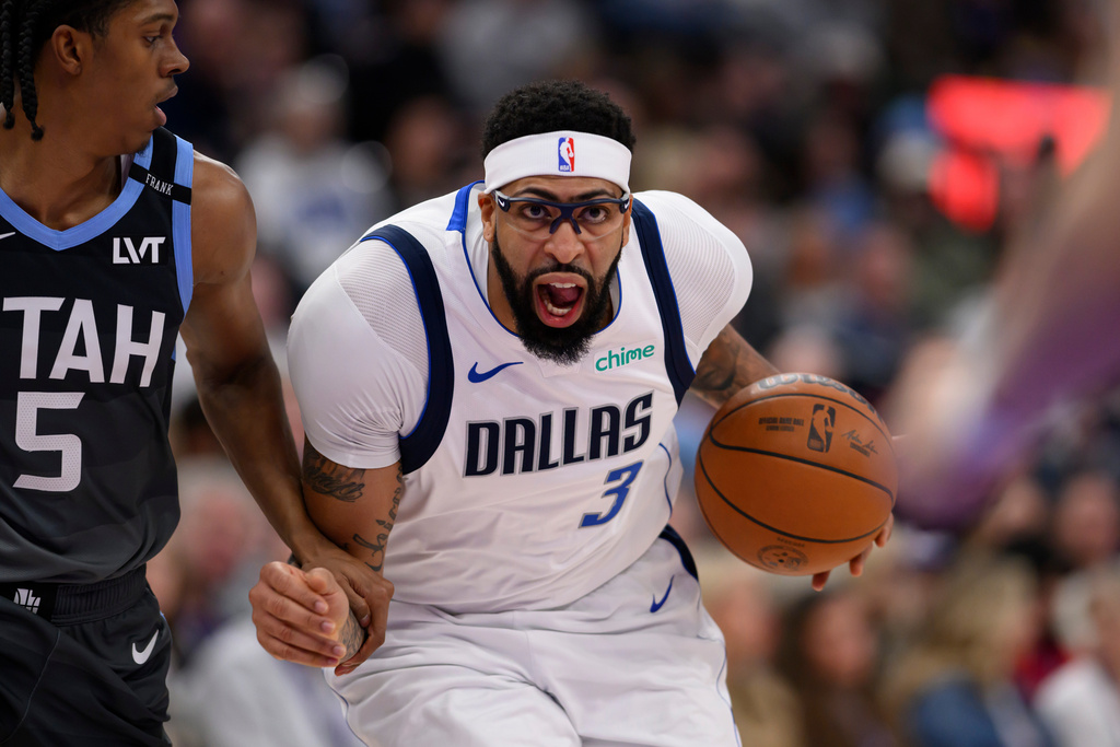 Dallas Mavericks forward Anthony Davis (3) drives to the basket while guarded by Utah Jazz forward Cody Williams (5) during the first half of an NBA basketball game, Thursday, Jan. 8, 2026, in Salt Lake City. (AP Photo/Tyler Tate)