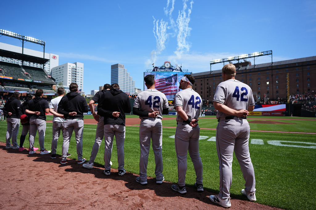 Arizona Diamondbacks players wear No. 42 to commemorate Jackie Robinson Day, as they observe the national anthem before a baseball game against the Baltimore Orioles, Wednesday, April 15, 2026, in Baltimore. (AP Photo/Stephanie Scarbrough)