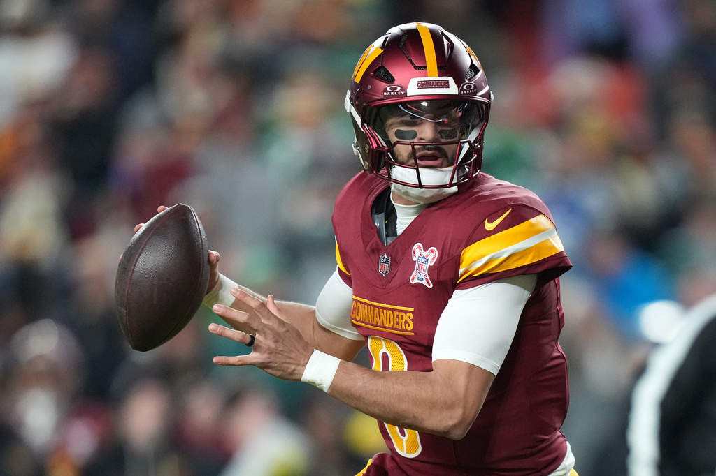 Washington Commanders quarterback Marcus Mariota looks to throw against the Philadelphia Eagles during the first half of an NFL football game, Saturday, Dec. 20, 2025, in Landover, Md. (AP Photo/Stephanie Scarbrough)