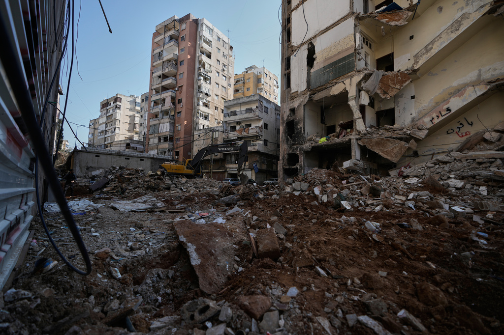 A bulldozer clears the rubble where a sports clothing shop was destroyed in a previous Israeli airstrike in Chiyah, a southern Beirut suburb, May 6, 2026. (AP Photo/Bilal Hussein)