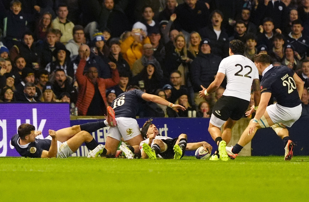 New Zealand's Damian McKenzie scores their side's third try during the Quilter Nations Series rugby match between Scotland and New Zealand in Edinburgh, Scotland, Saturday, Nov. 8, 2025. (Andrew Milligan/PA via AP)