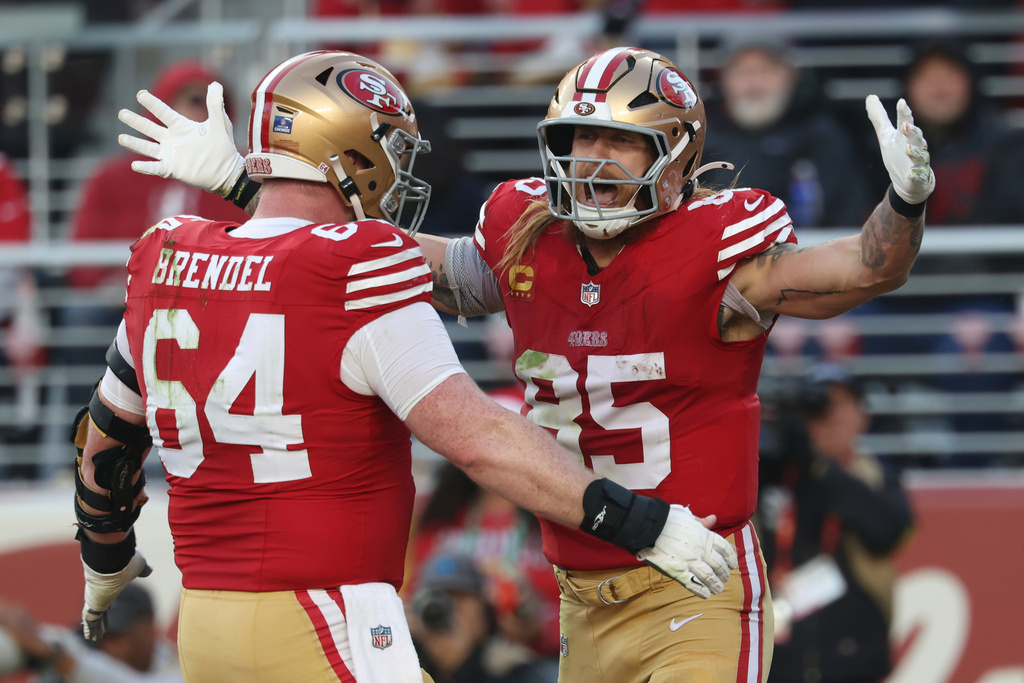 San Francisco 49ers tight end George Kittle (85) celebrates his touchdown with center Jake Brendel (64) during the second half of an NFL football game against the Tennessee Titans, Sunday, Dec. 14, 2025, in Santa Clara, Calif. (AP Photo/Jed Jacobsohn)