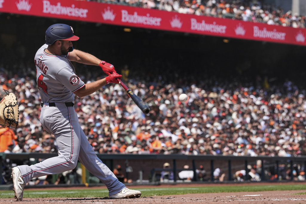 Washington Nationals' Paul DeJong hits an RBI single during the sixth inning of a baseball game against the San Francisco Giants, Sunday, Aug. 10, 2025, in San Francisco. (AP Photo/Godofredo A. Vásquez)