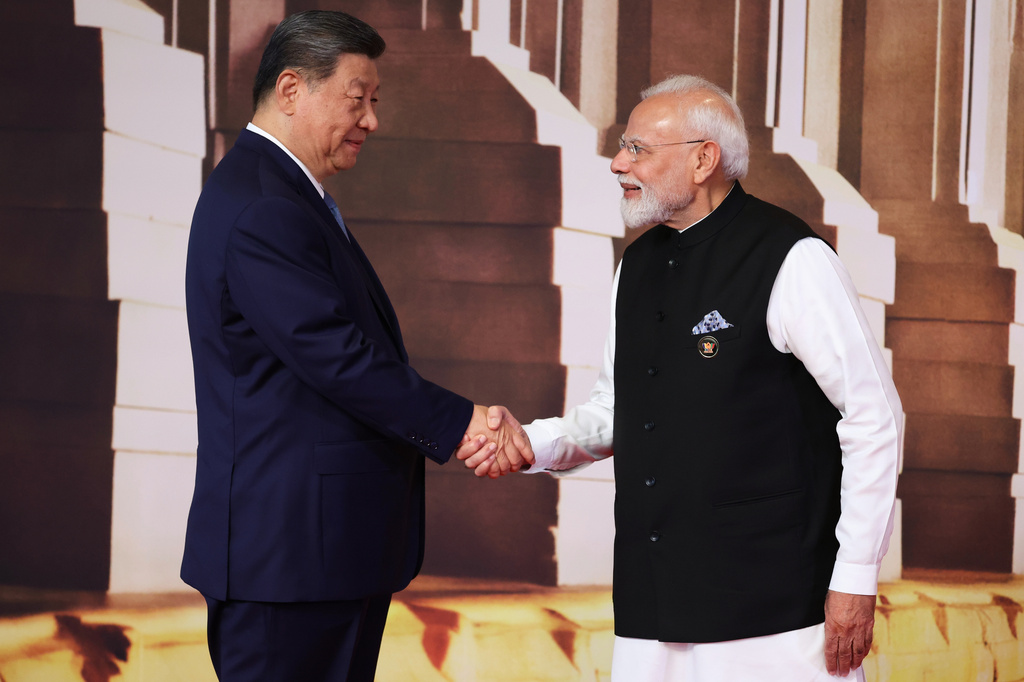 Chinese President Xi Jinping, left, and Indian Prime Minister Narendra Modi shake hands during a welcoming ceremony at the BRICS Summit in New Delhi, India, Saturday, Sept. 12, 2026. (Alexander Kazakov, Sputnik, Kremlin Pool Photo via AP)