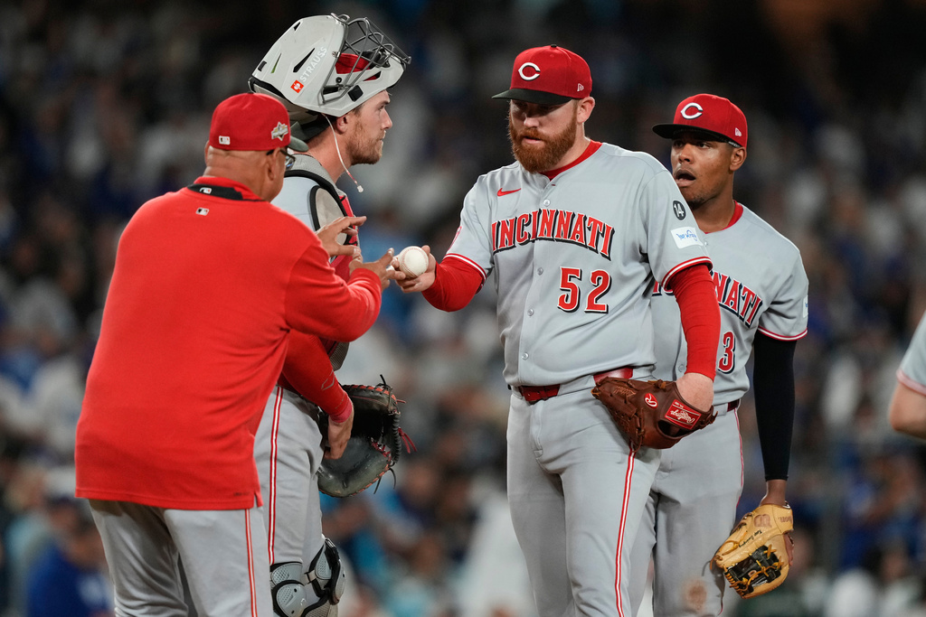 Cincinnati Reds manager Terry Francona, left, walks up to mound to replace starting pitcher Zack Littell (52) during the fourth inning in Game 2 of the National League Wild Card baseball playoff series against the Los Angeles Dodgers, Wednesday, Oct. 1, 2025, in Los Angeles. (AP Photo/Mark J. Terrill)