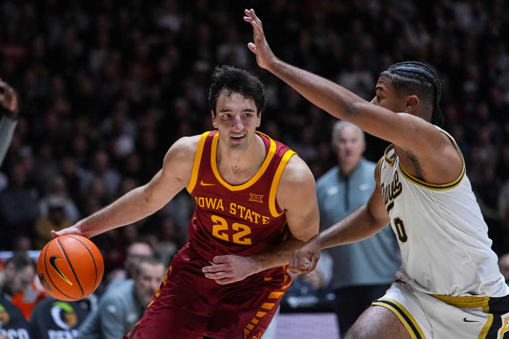 Iowa State forward Milan Momcilovic (22) drives on Purdue guard C.J. Cox (0) during the first half of an NCAA college basketball game in West Lafayette, Ind., Saturday, Dec. 6, 2025. (AP Photo/Michael Conroy)