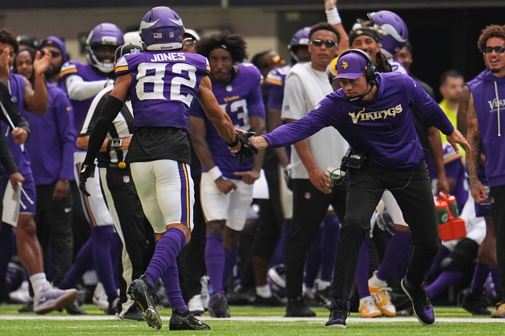 Minnesota Vikings wide receiver Jeshaun Jones (82) celebrates with head coach Kevin O'Connell after completing a 35-yard catch during the first half of an NFL preseason football game against the Baltimore Ravens, Saturday, Aug. 22, 2026, in Minneapolis. (AP Photo/Abbie Parr)