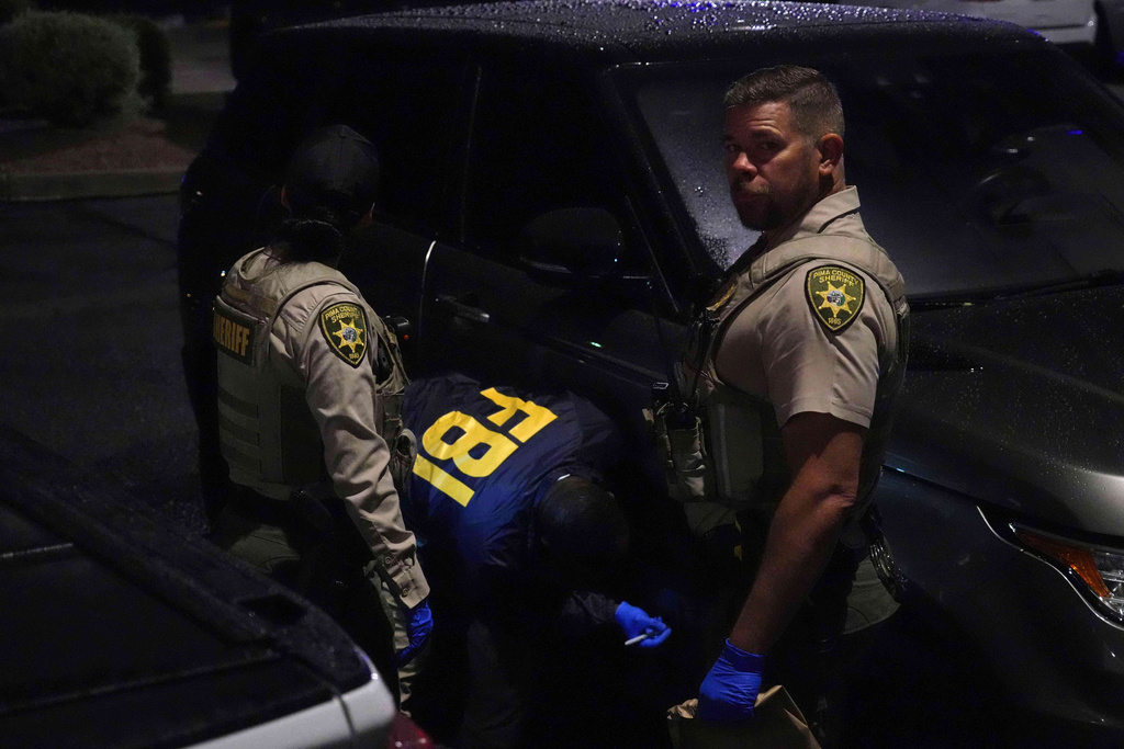 Pima County sheriff and FBI work on a Range Rover in a Culver’s parking lot in Tucson, Ariz. early Saturday, Feb. 14, 2026. (AP Photo/Ty ONeil)